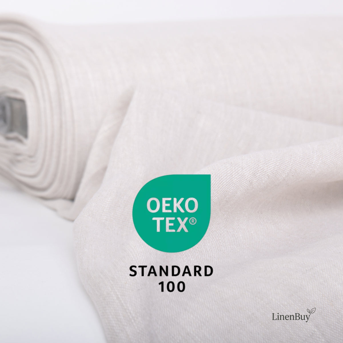 A close-up of a rolled off-white fabric with a soft draped section in the foreground, featuring a green OEKO-TEX Standard 100 certification badge and the LinenBuy logo.