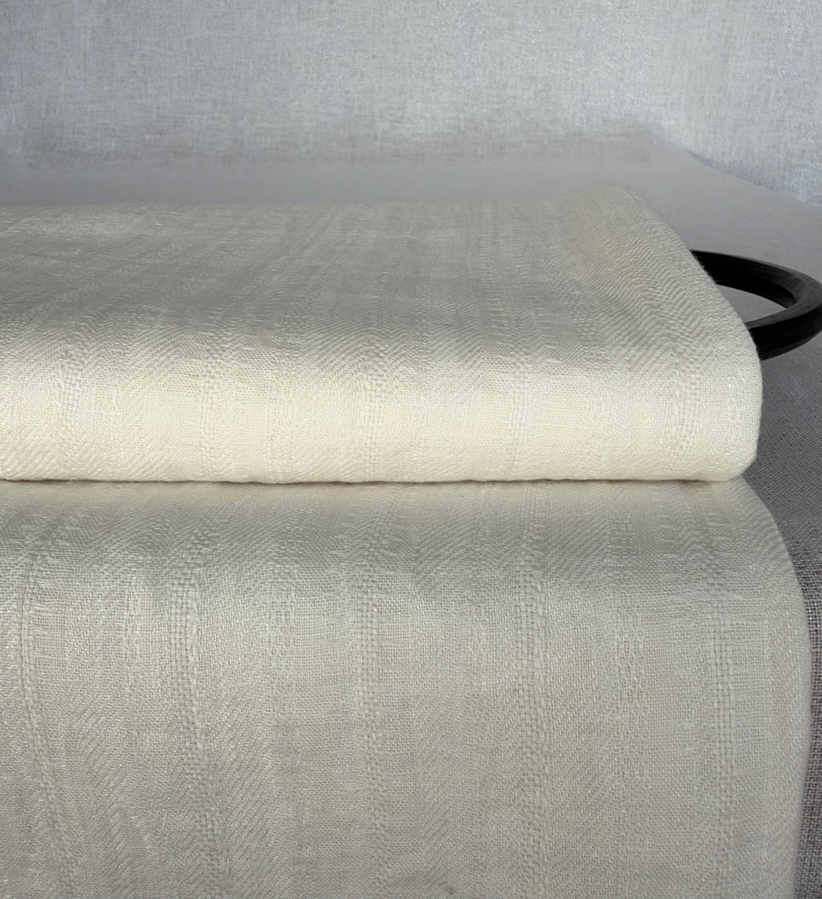 Off-white washed linen fabric with delicate vertical dobby stripes