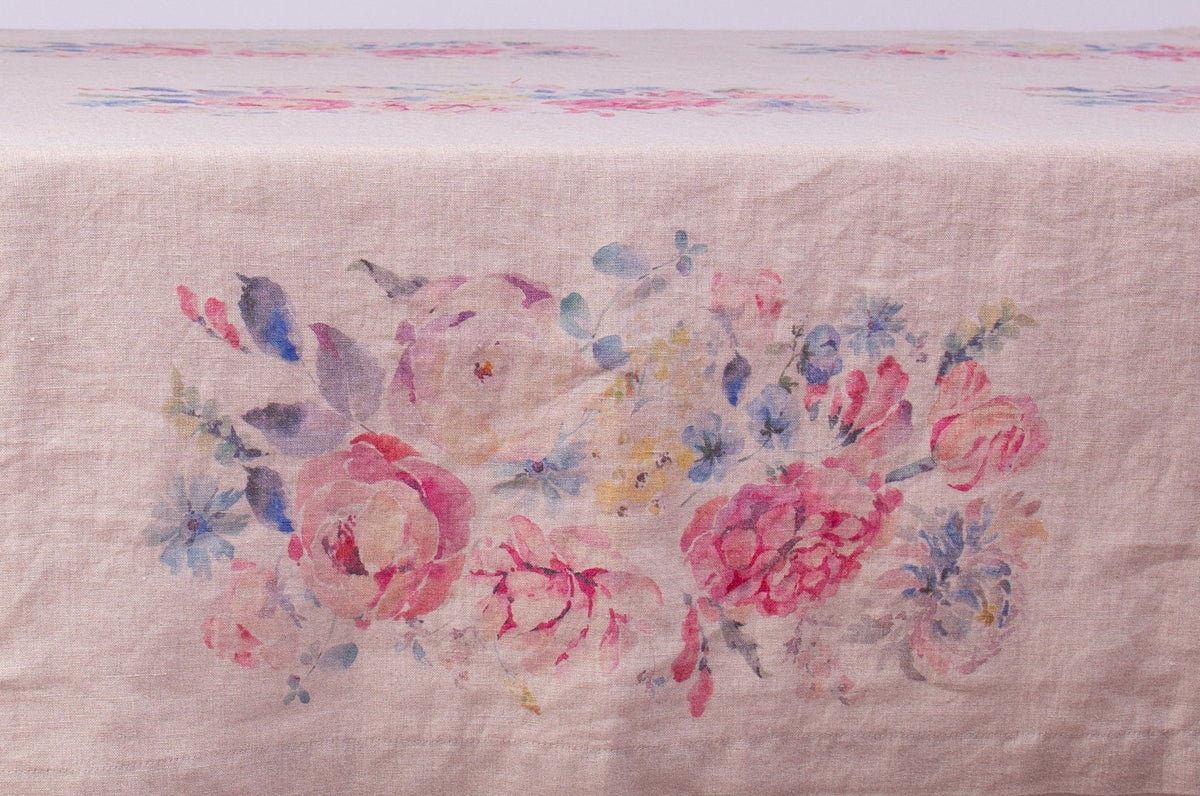 Floral tablecloth on a wooden table with a white background
